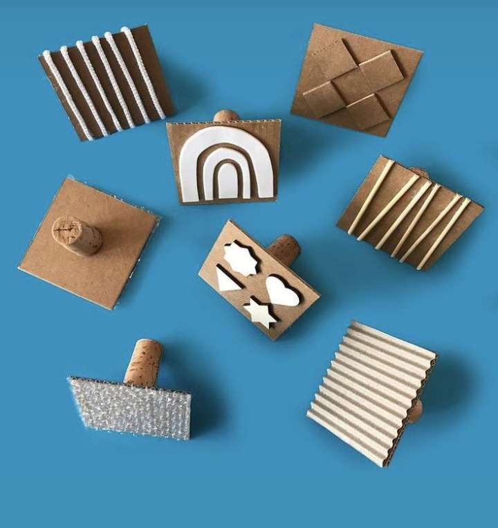Main Image: cute handmade paint stamps in different designs and shapes, made using cardboard, cork and other everyday materials. A fun and easy craft for kids.