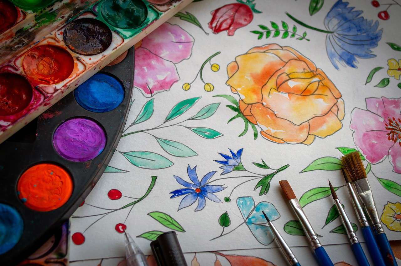 a close up of watercolour flowers and a watercolour paint pallet 