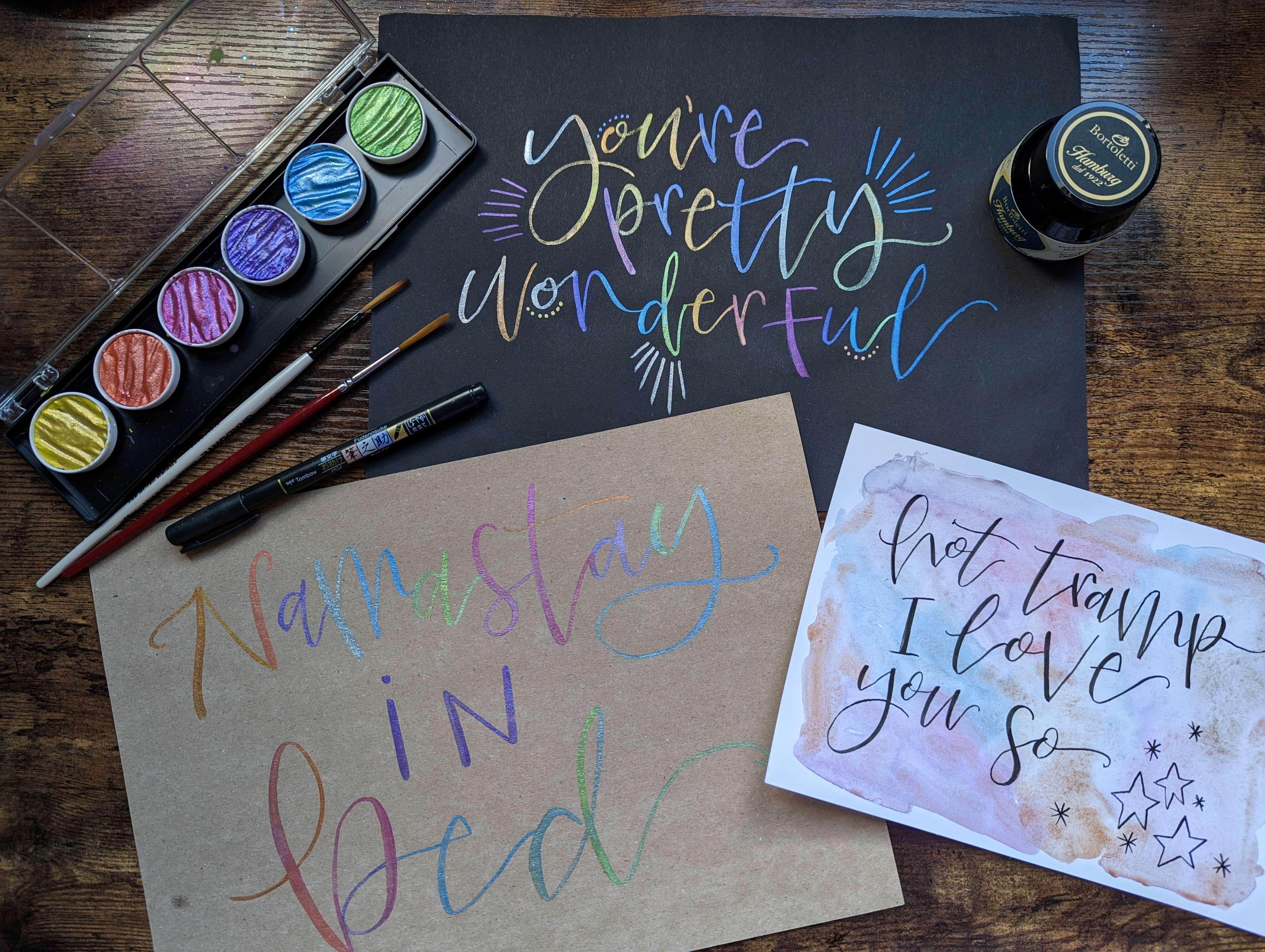 multicolour watercolour calligraphy on black card