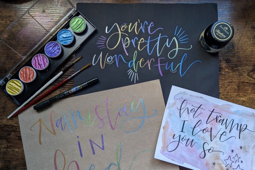multicolour watercolour calligraphy on black card