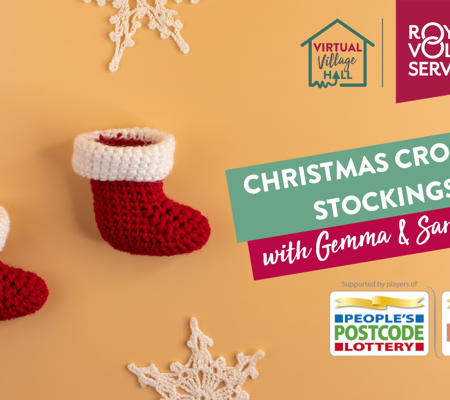 three red and white mini crochet Christmas stockings lined up on a white background surrounded by Christmas fairy lights