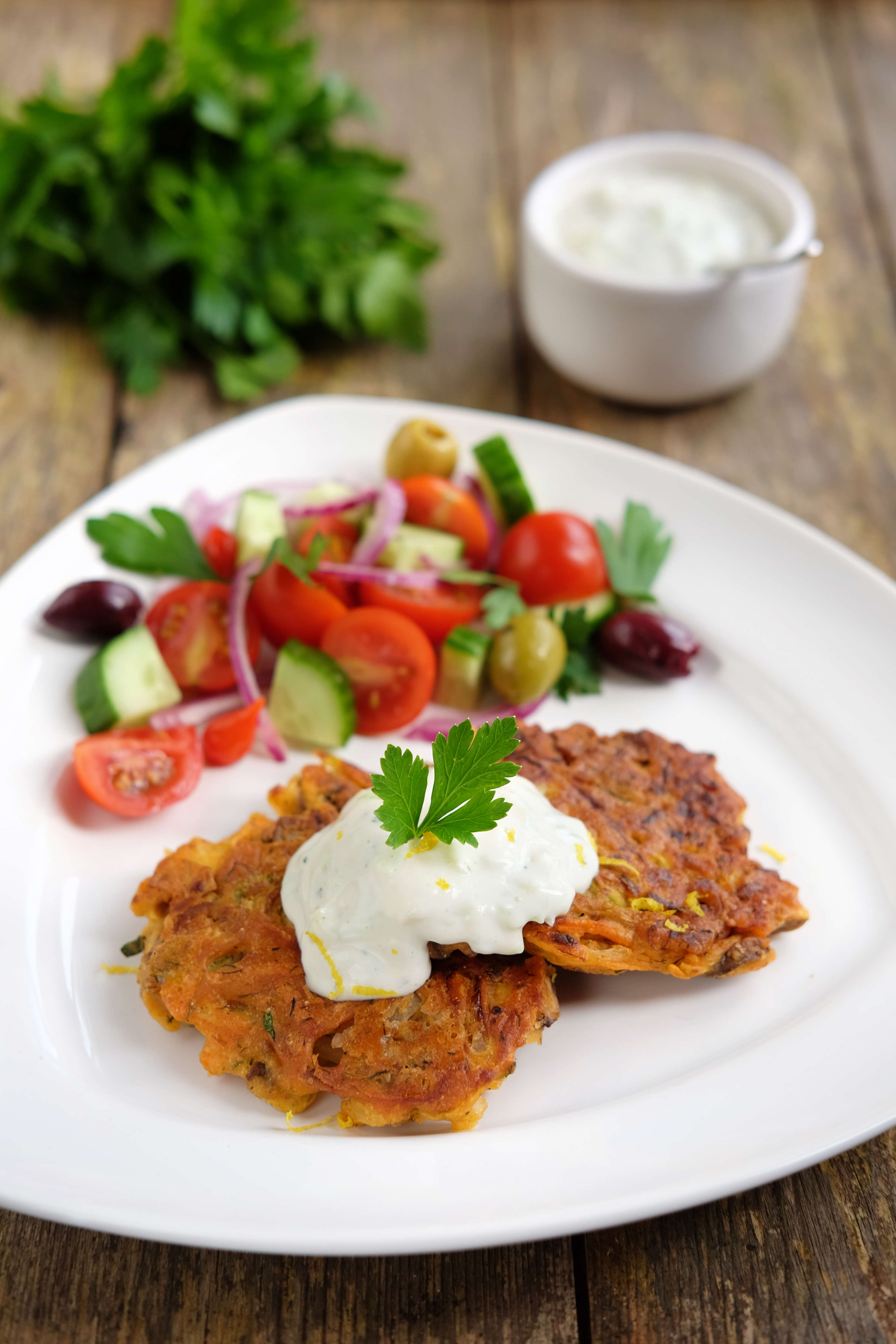 a white dinner plate with a vegan leftover fritter on top