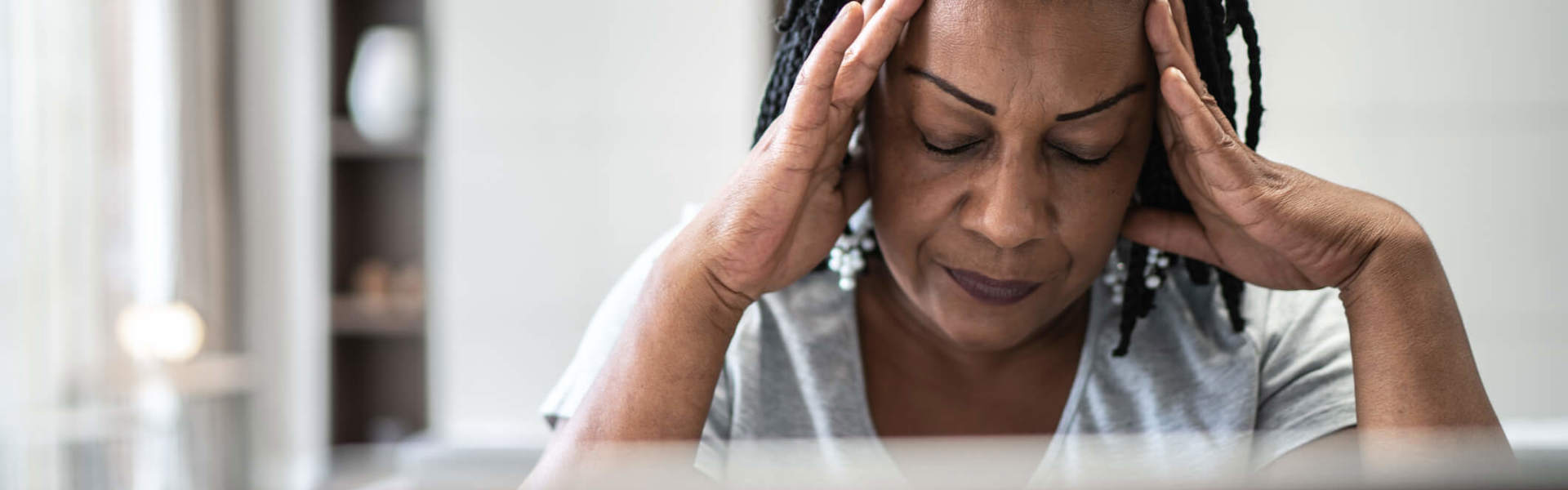 a woman with her head in her hands looking stressed