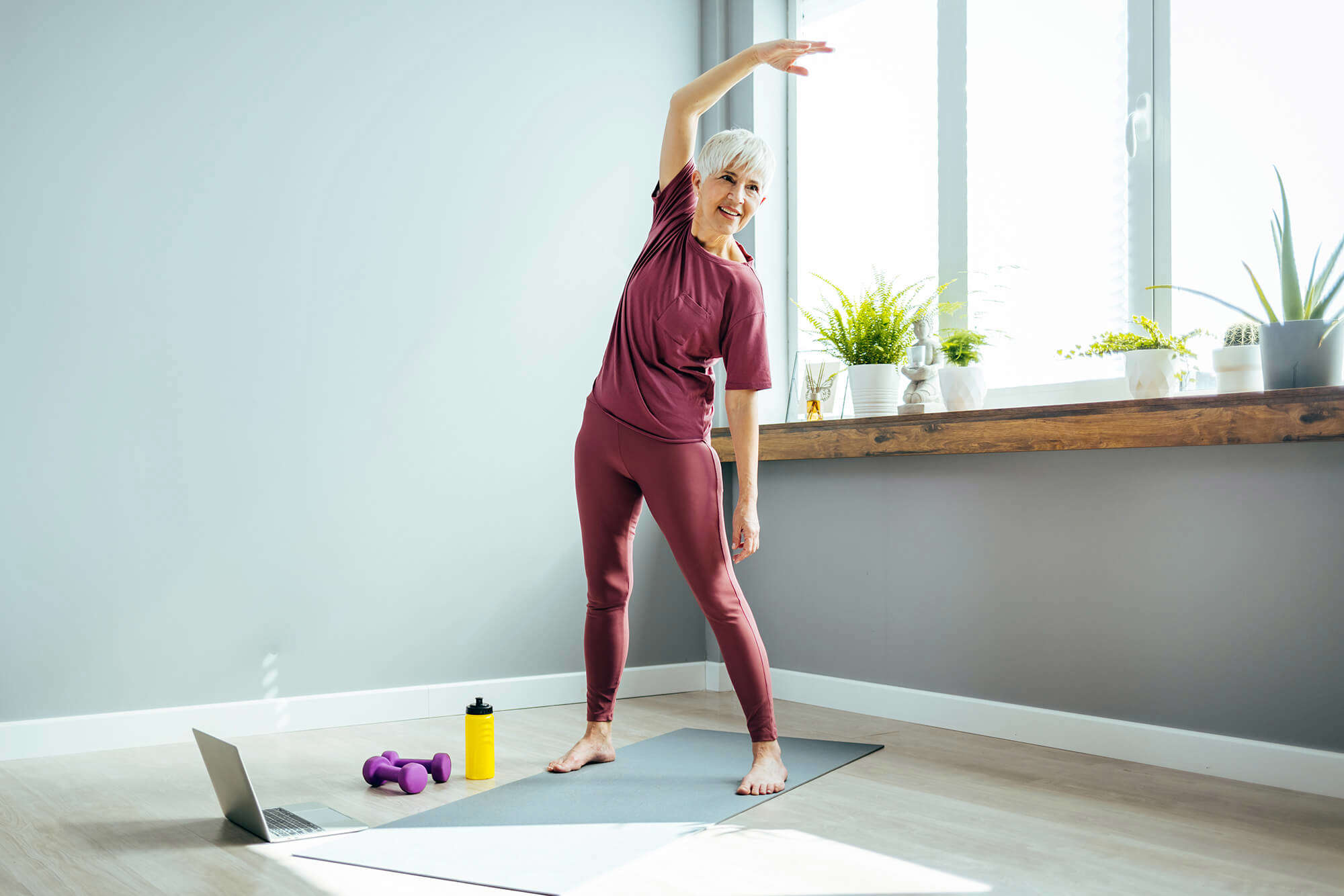 A woman taking a standing pilates class