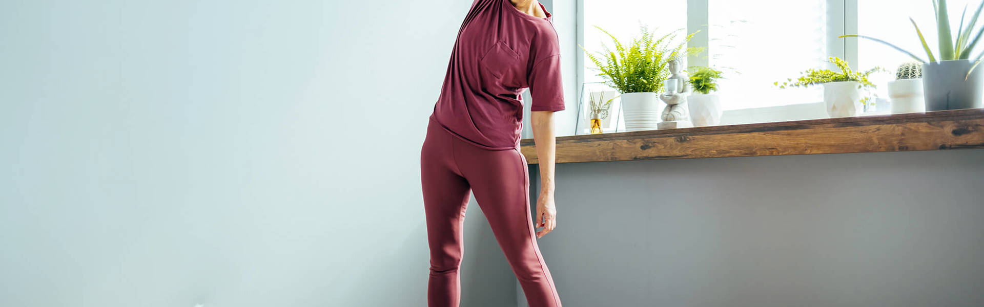 A woman taking a standing pilates class