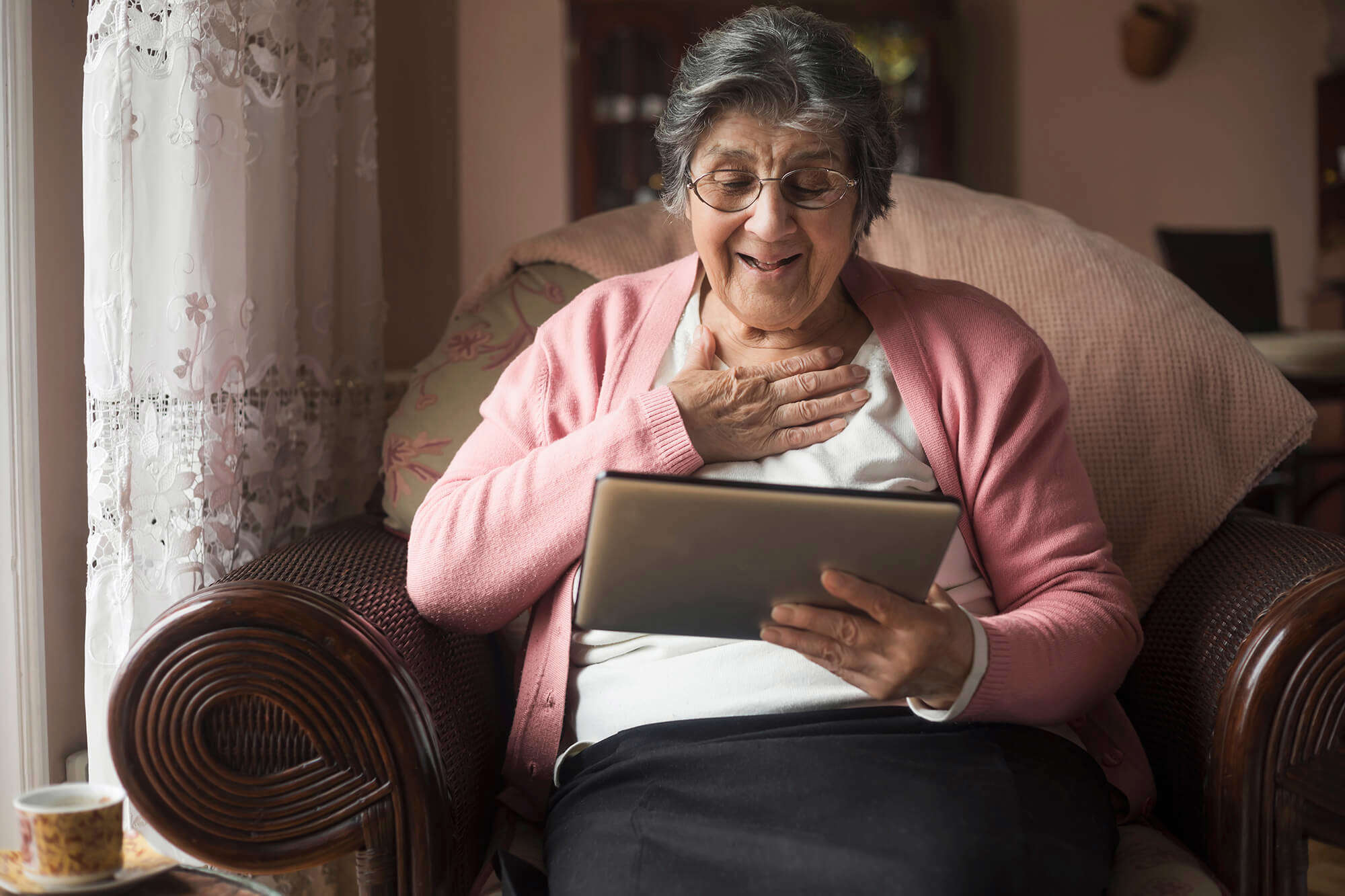 An older lady looking at a tablet 