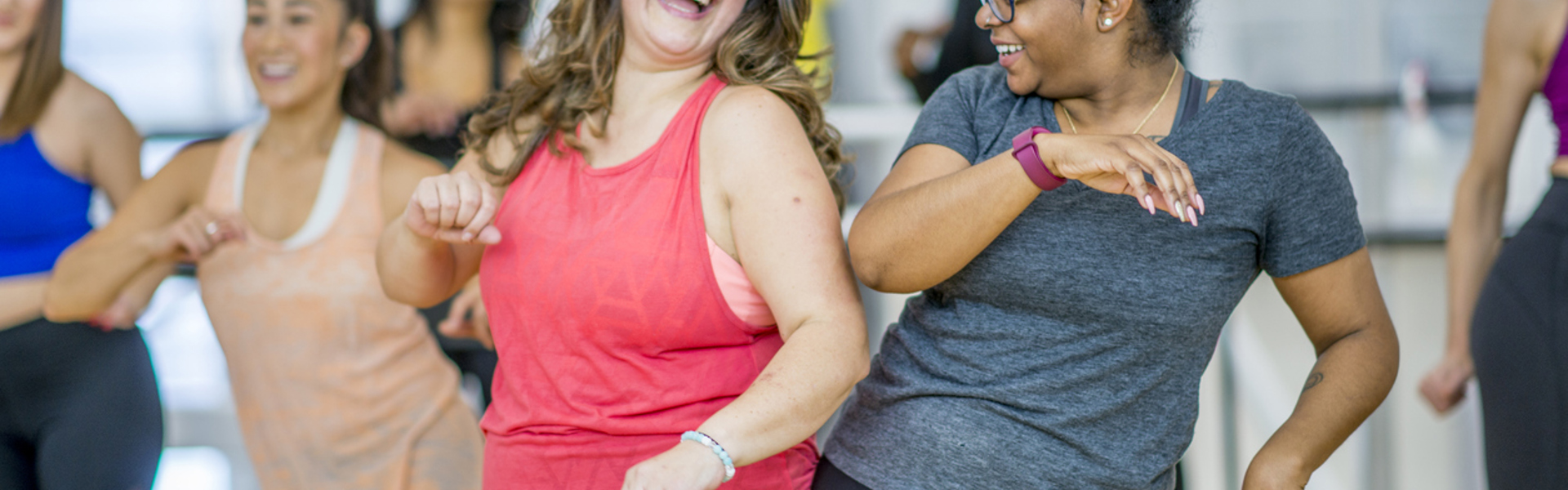 two women dancing and having fun in an exercise class