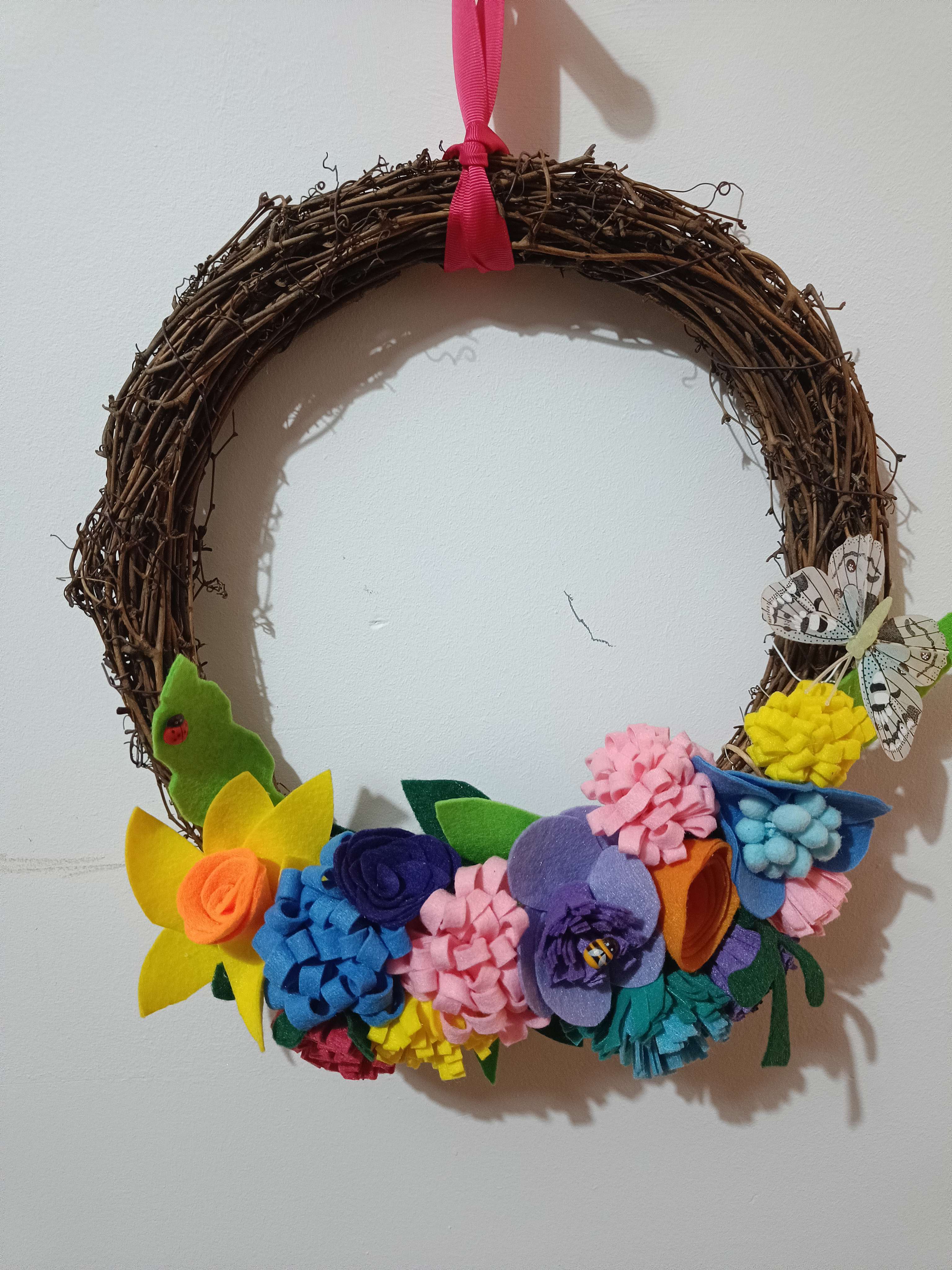 A close up of a summer felt wreath made by Gemma Forde