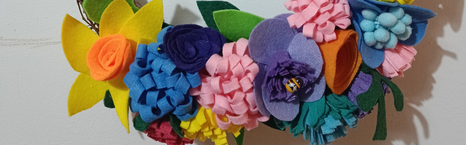 A close up of a summer felt wreath made by Gemma Forde