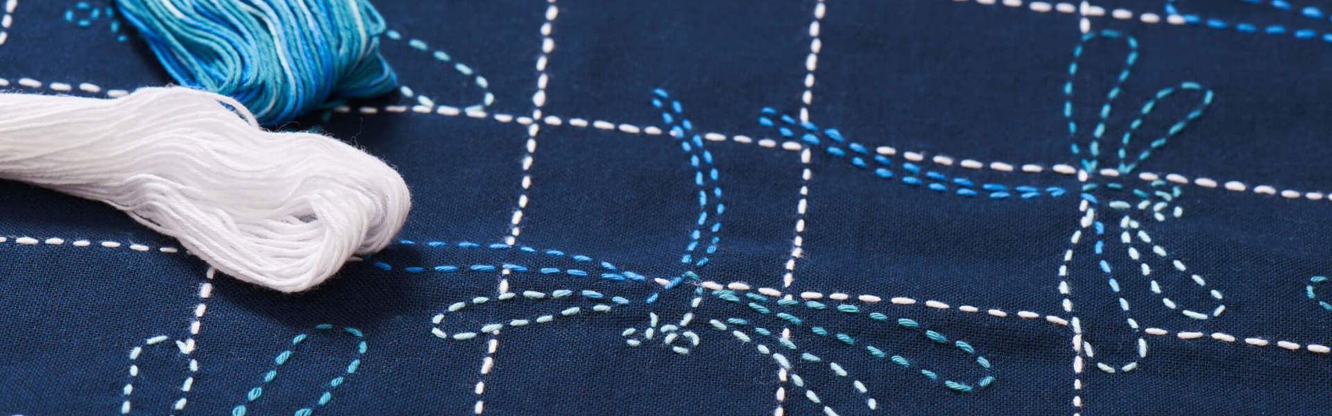 a close up of a sashiko print dragonfly