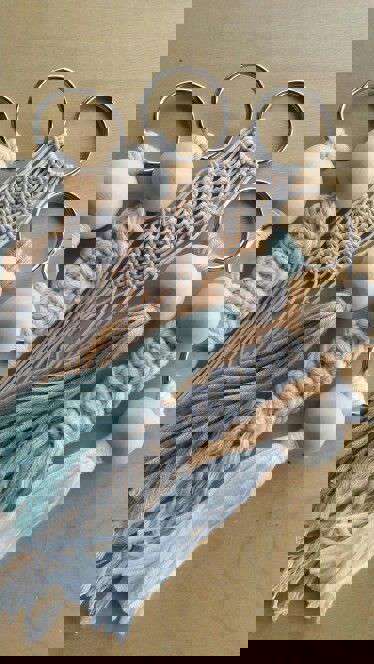 Main image: Cute Handmade Macrame Keychains made by Kate Nisbet, using white, cream and blue wool with wooden bead accessories.