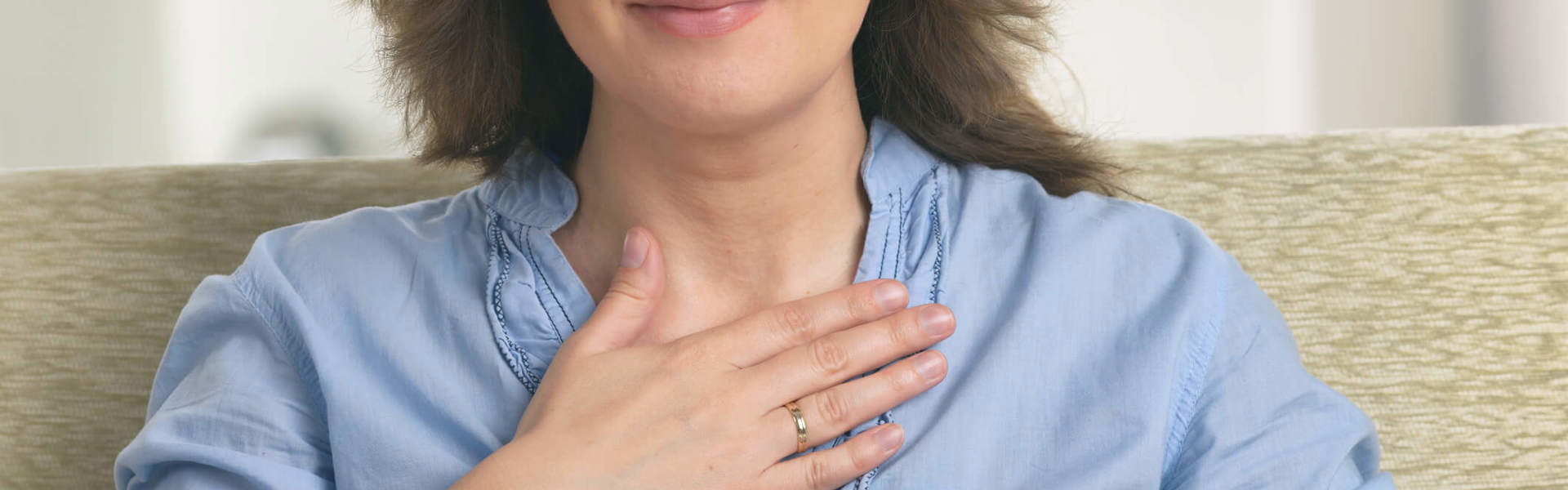 a woman with her eyes closed and hands on her chest