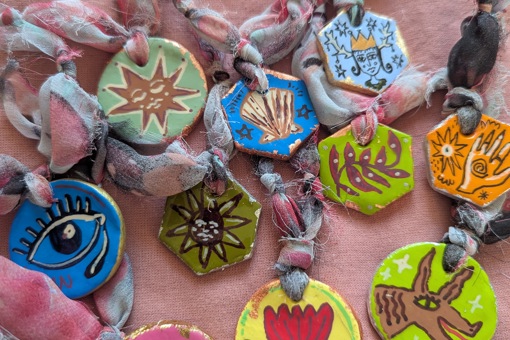 Main image: brightly hand painted, air dry clay pendants. 