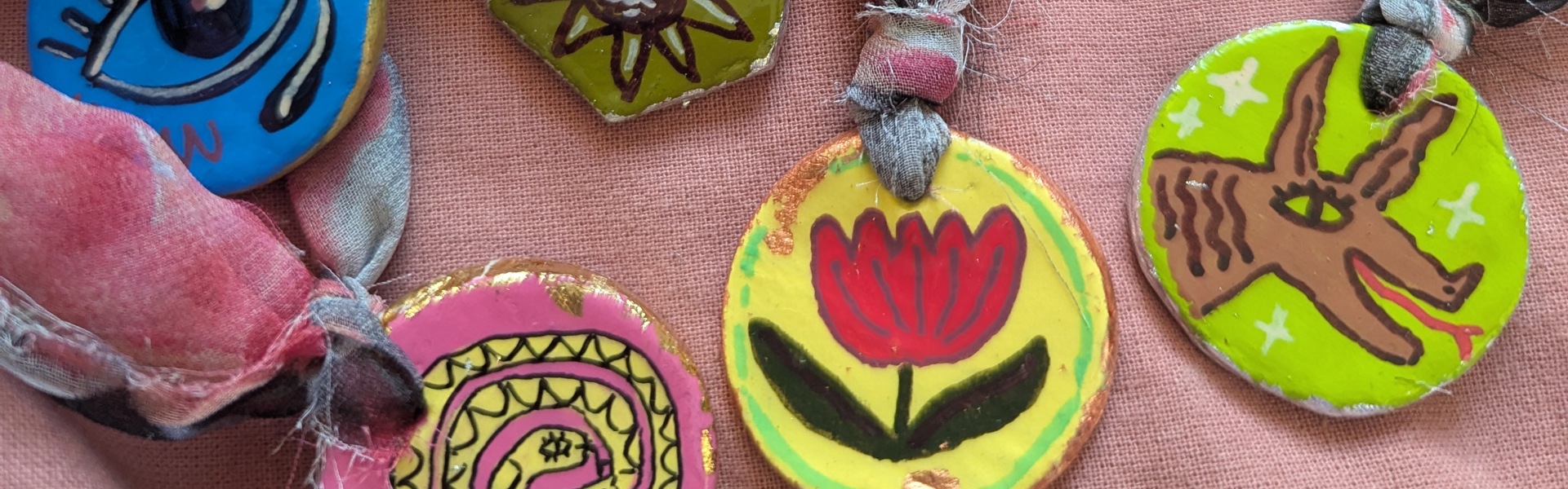 Main image: brightly hand painted, air dry clay pendants. 