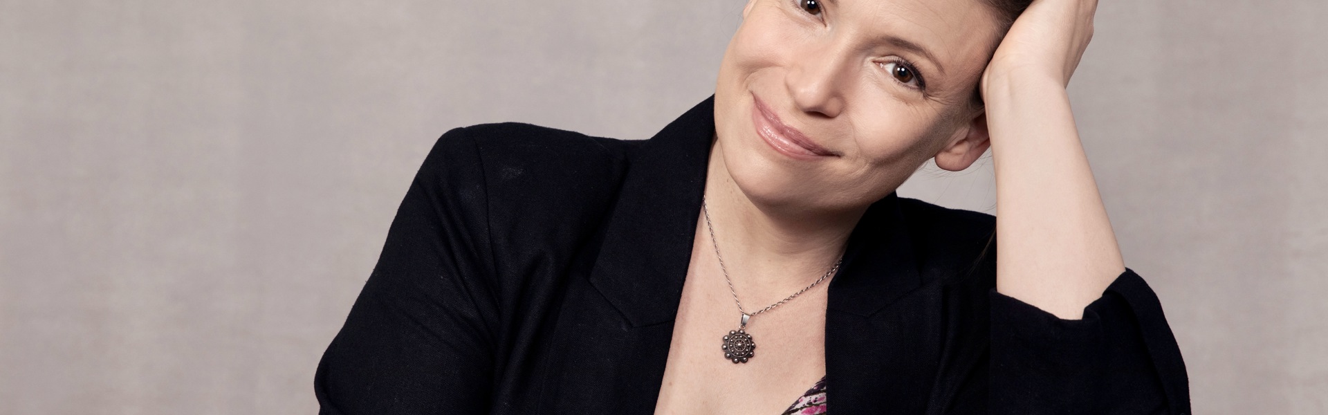 Main image: headshot photo of Julia Whelan, award winning audiobook narrator, wearing a black blazer and floral top smiling.