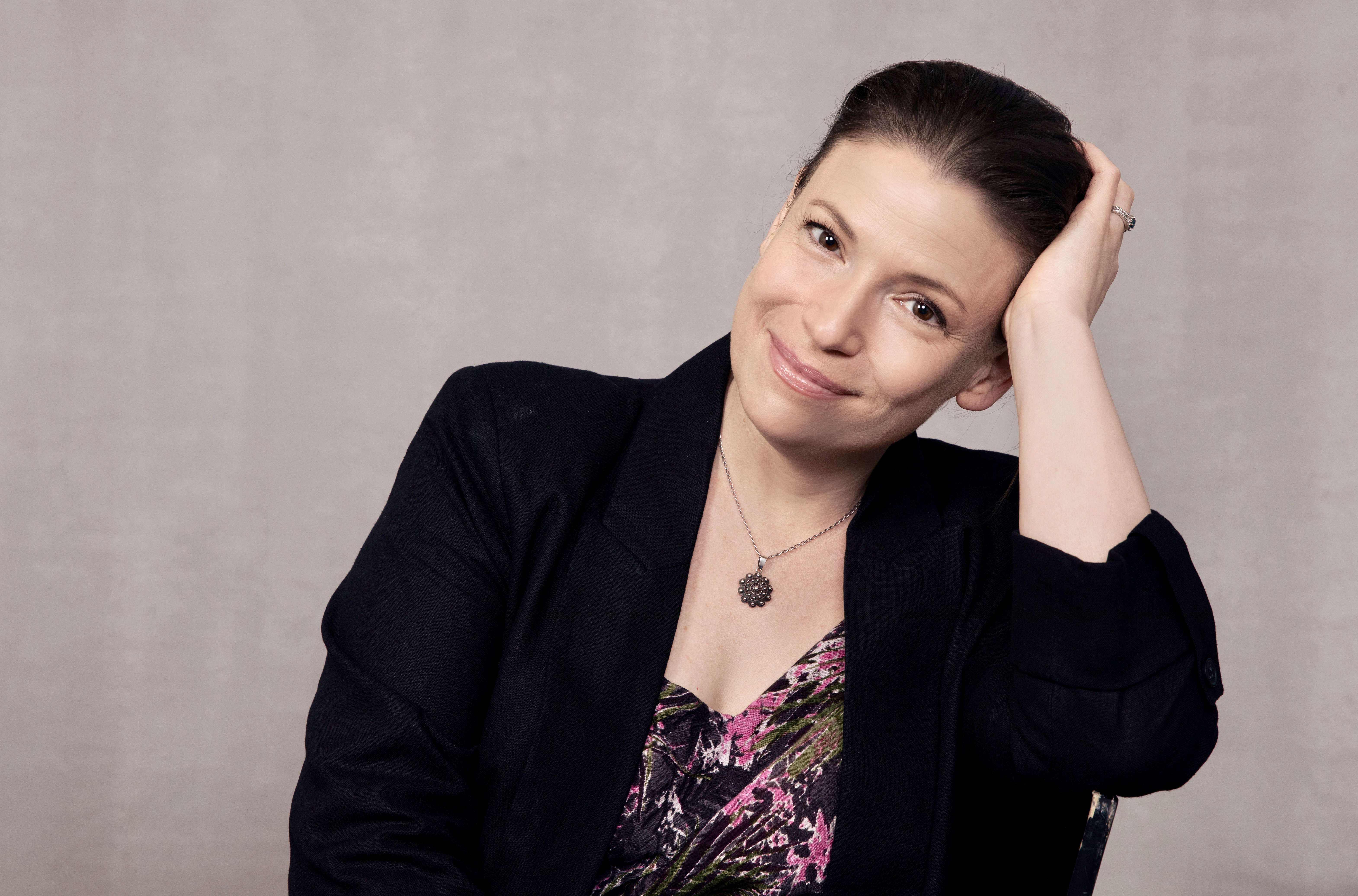 Main image: headshot photo of Julia Whelan, award winning audiobook narrator, wearing a black blazer and floral top smiling.