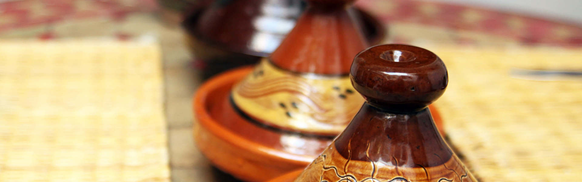 Authentic traditional ceramic Moroccan tagine pots in a row