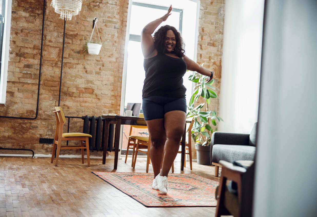 a woman dancing in her living room