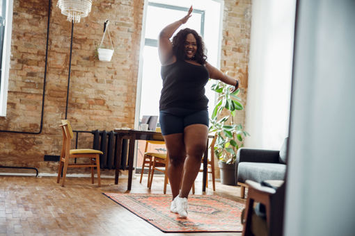 a woman dancing in her living room