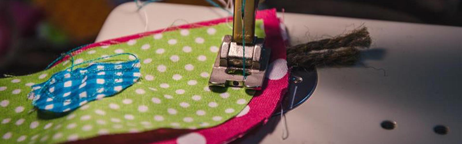 Main image: using a sewing machine to sew pieces of scrap fabric together to make a fabric gift bag.