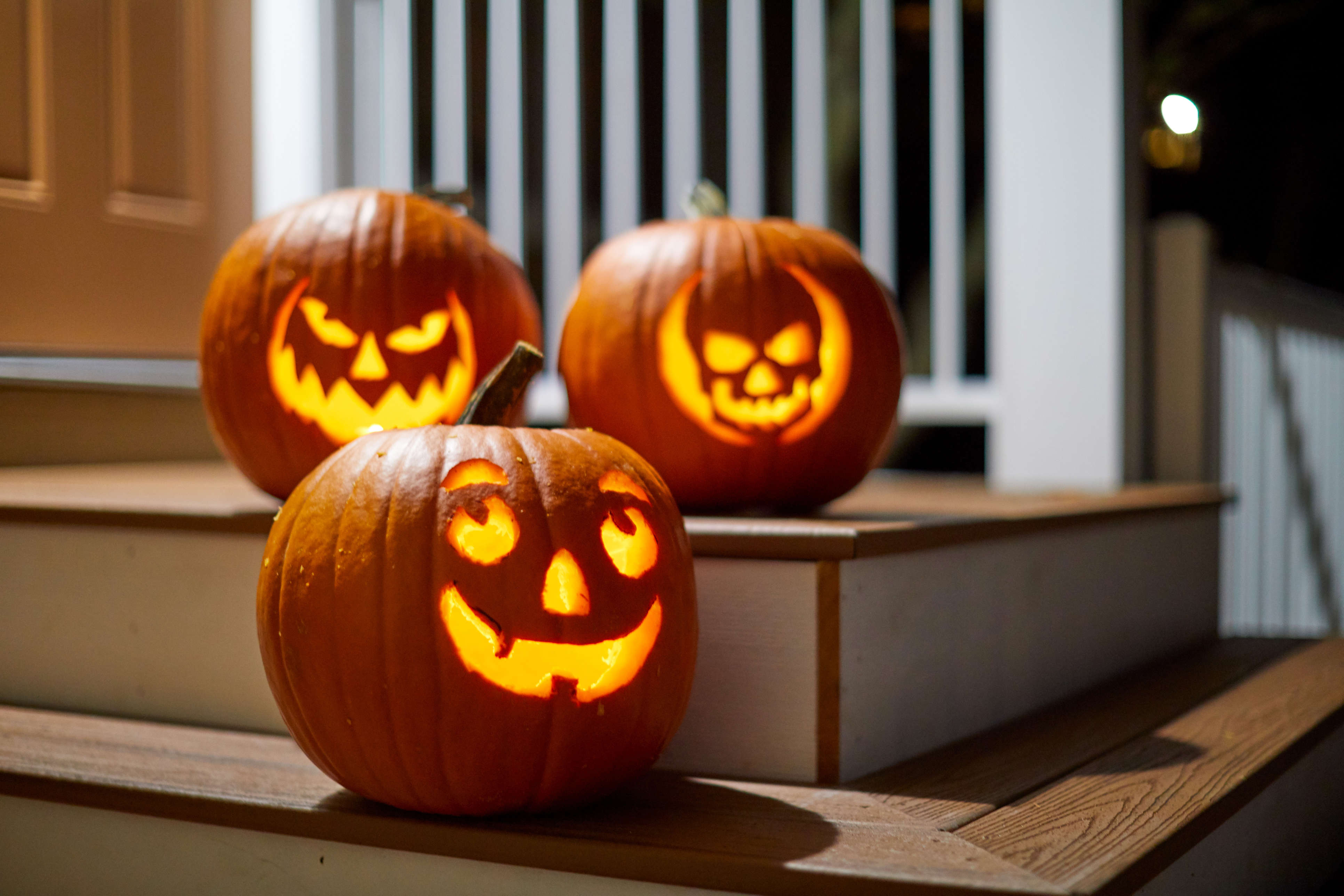 a carved Halloween pumpkin lit up with a tea light