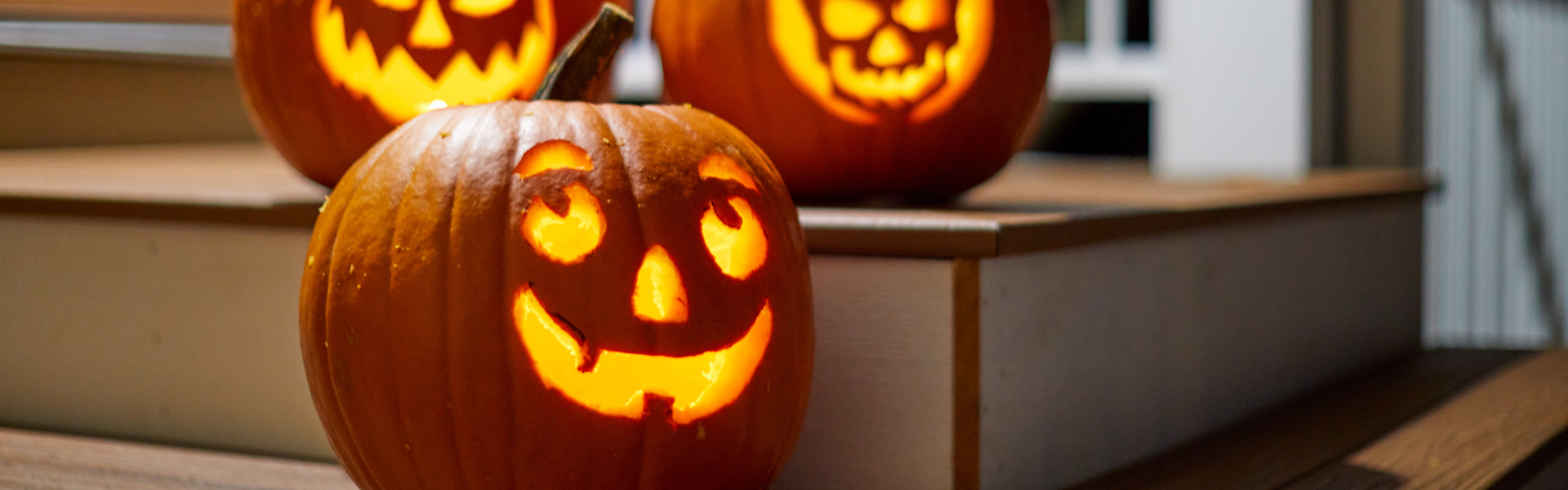 a carved Halloween pumpkin lit up with a tea light