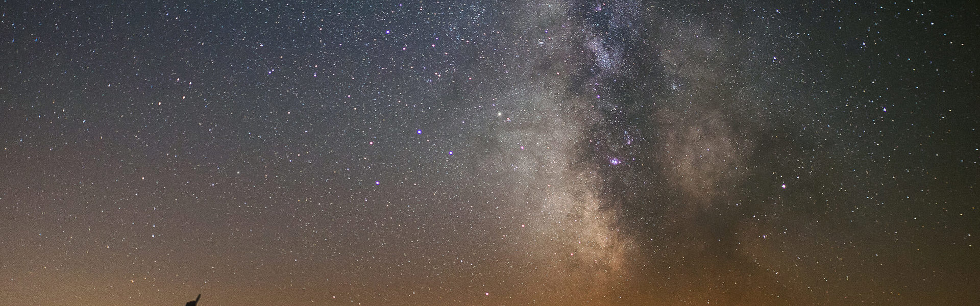 a silhouette of two people stargazing