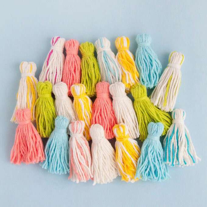 multicoloured yarn tassels on a blue background