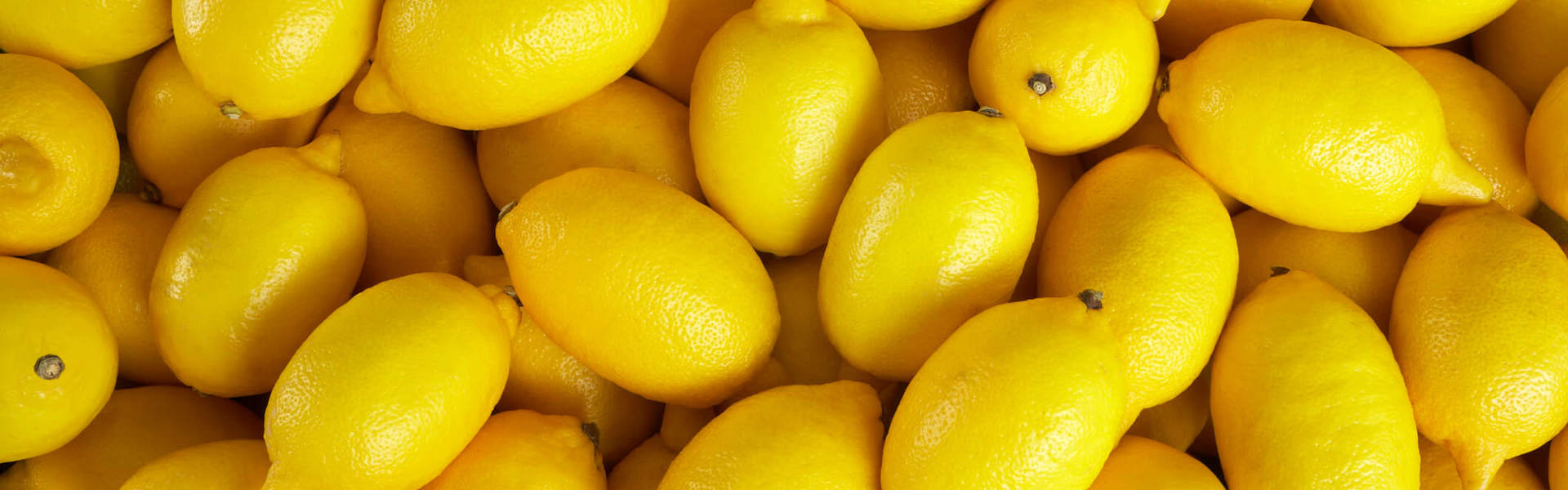 a pile of bright yellow lemons