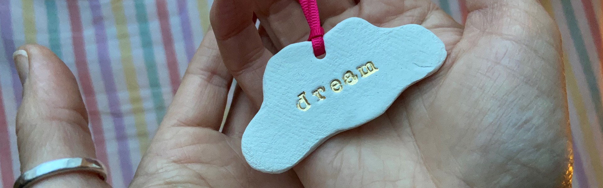 a ceramic cloud keepsake with the word dream engraved into it