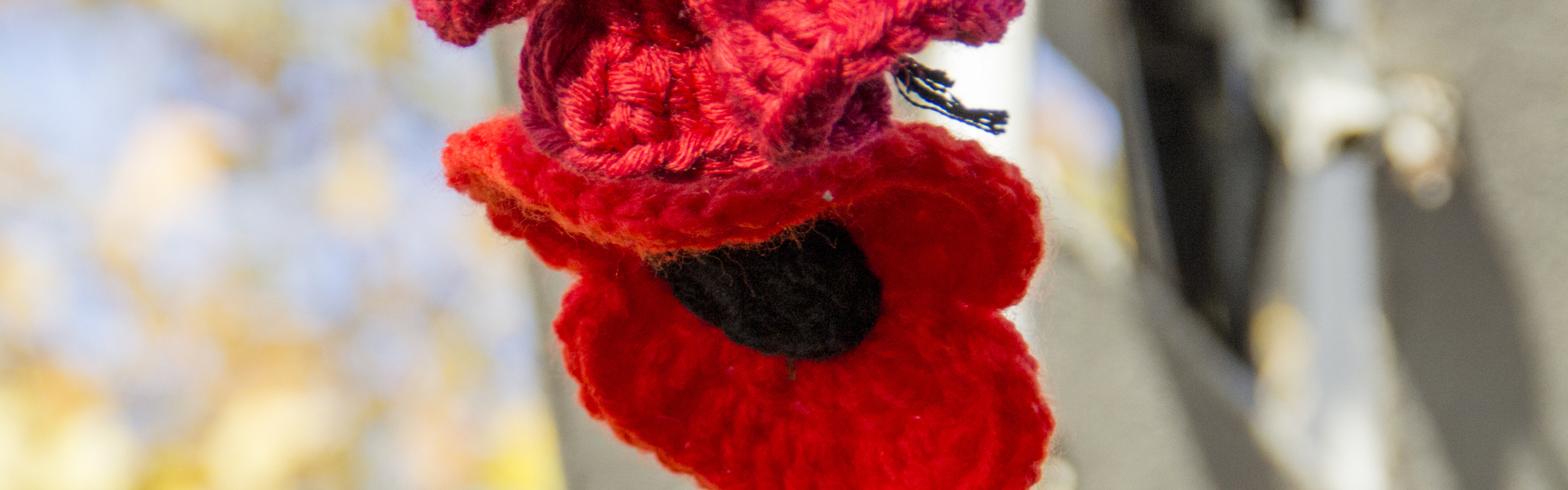 a close up of knitted poppies