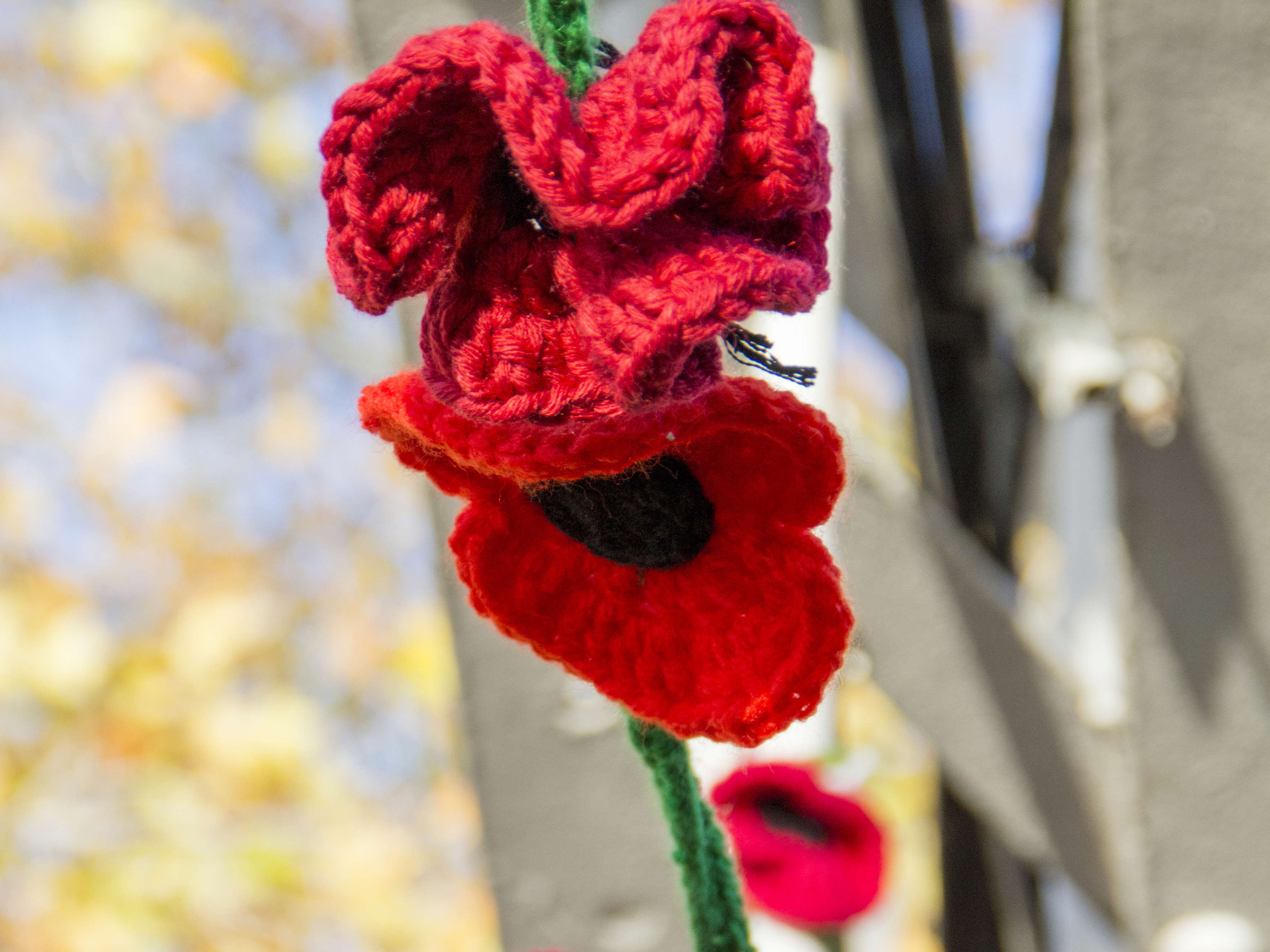 a close up of knitted poppies