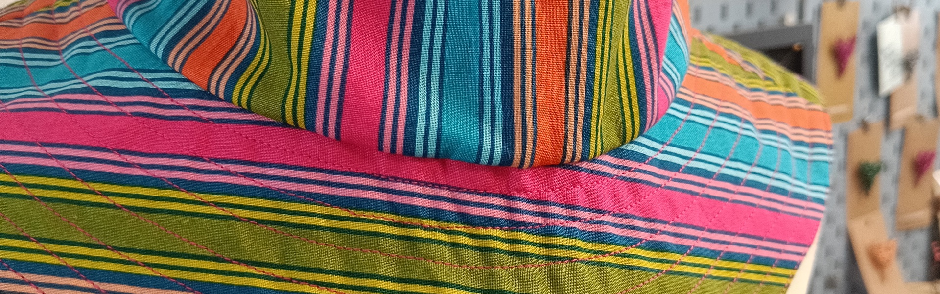 a summer bucket hat with a festival setting in the background