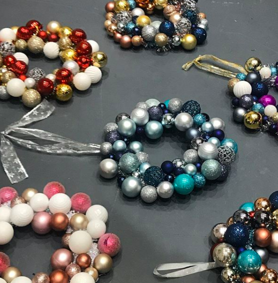 Handmade Christmas bauble wreaths laying on a table