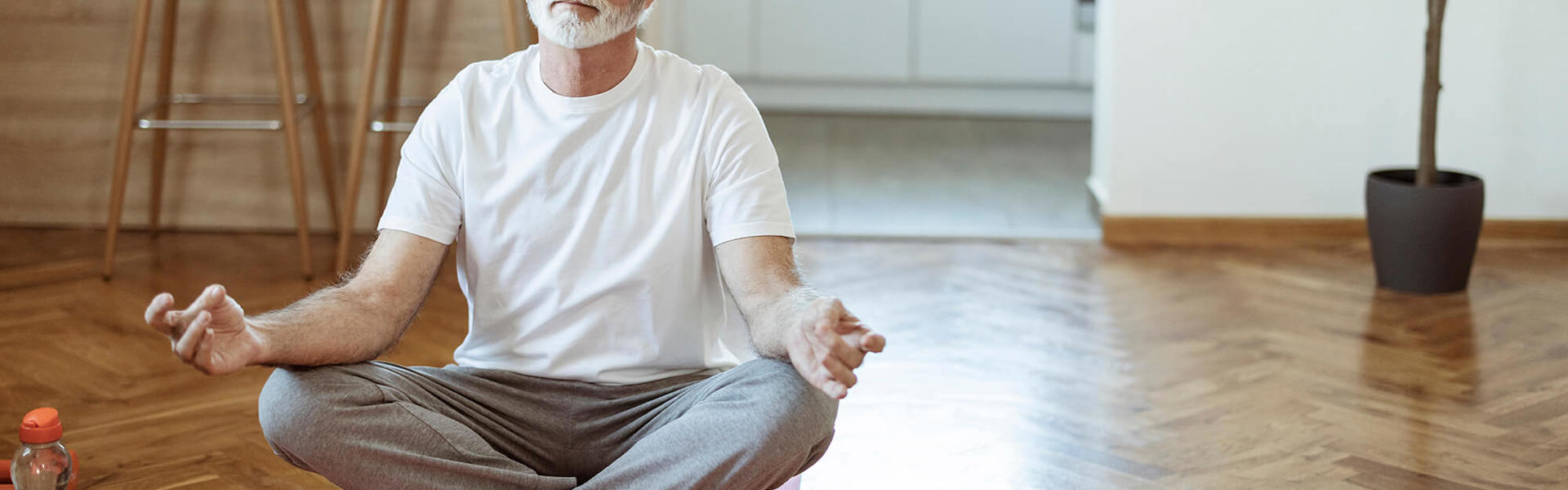 A man doing a yoga session at home