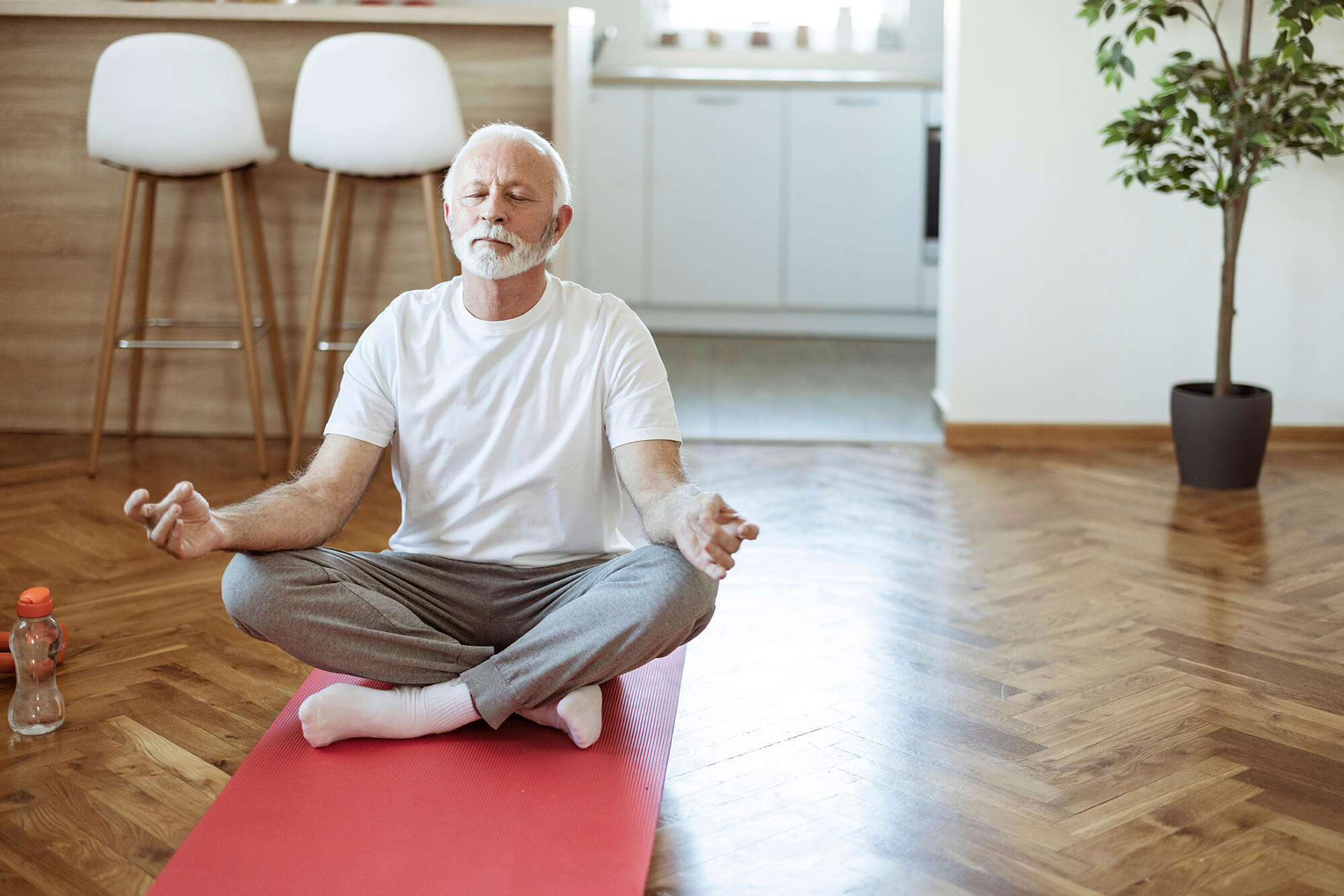 A man doing a yoga session at home