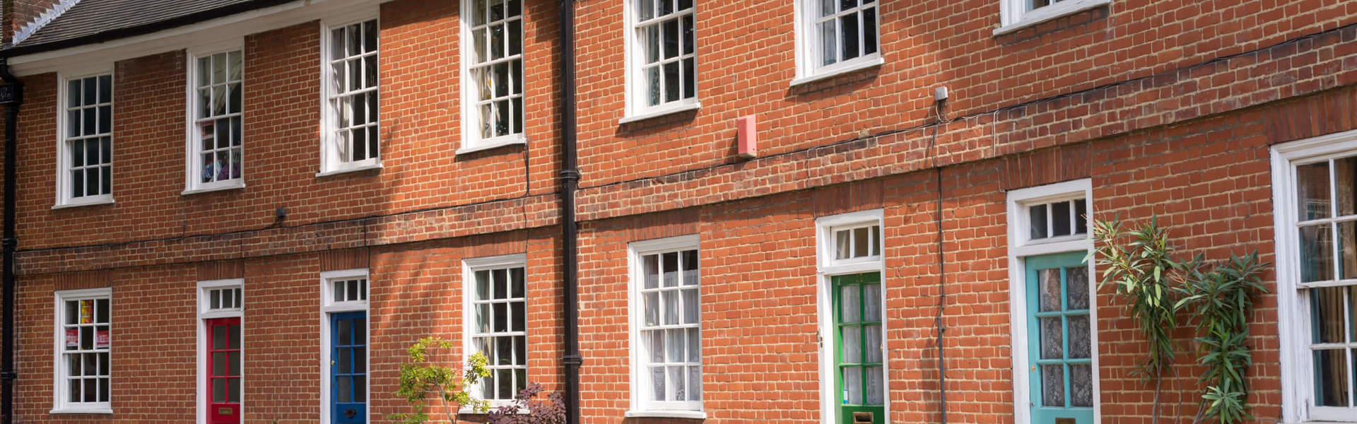 Restored Victorian red brick houses with coloured doors