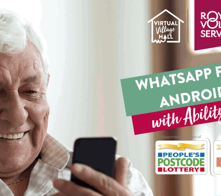 a older man looking at his phone and smiling