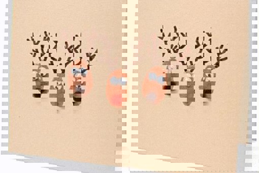 Main image: cute handmade Christmas card with three adorable reindeers faces on the front.