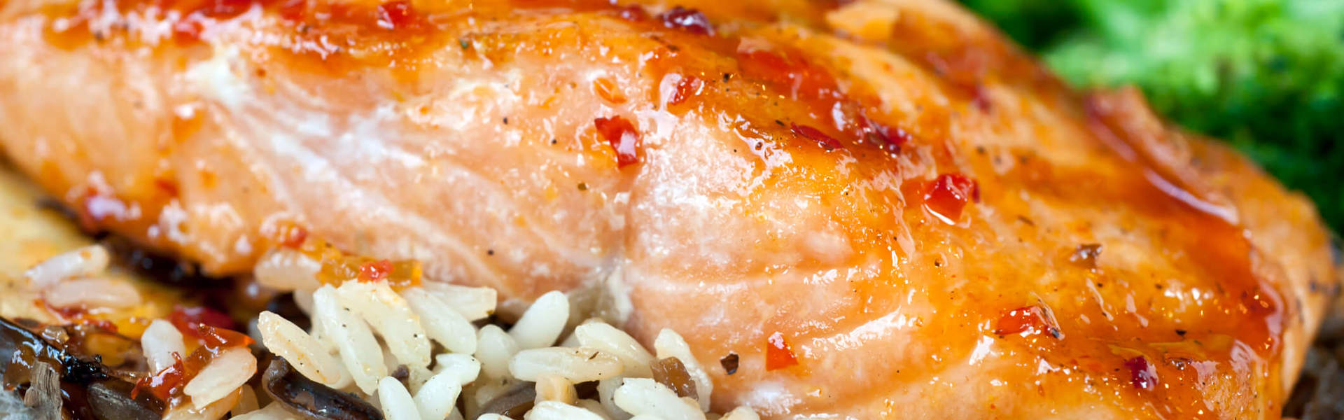 a fillet of baked salmon on a bed of wild rice