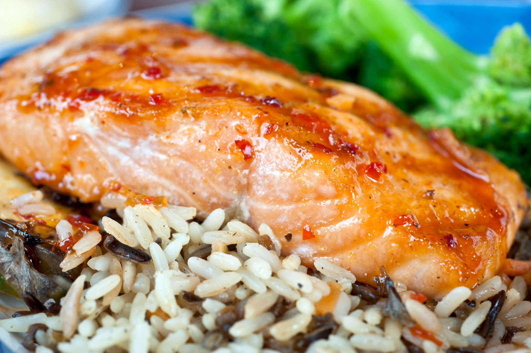 a fillet of baked salmon on a bed of wild rice