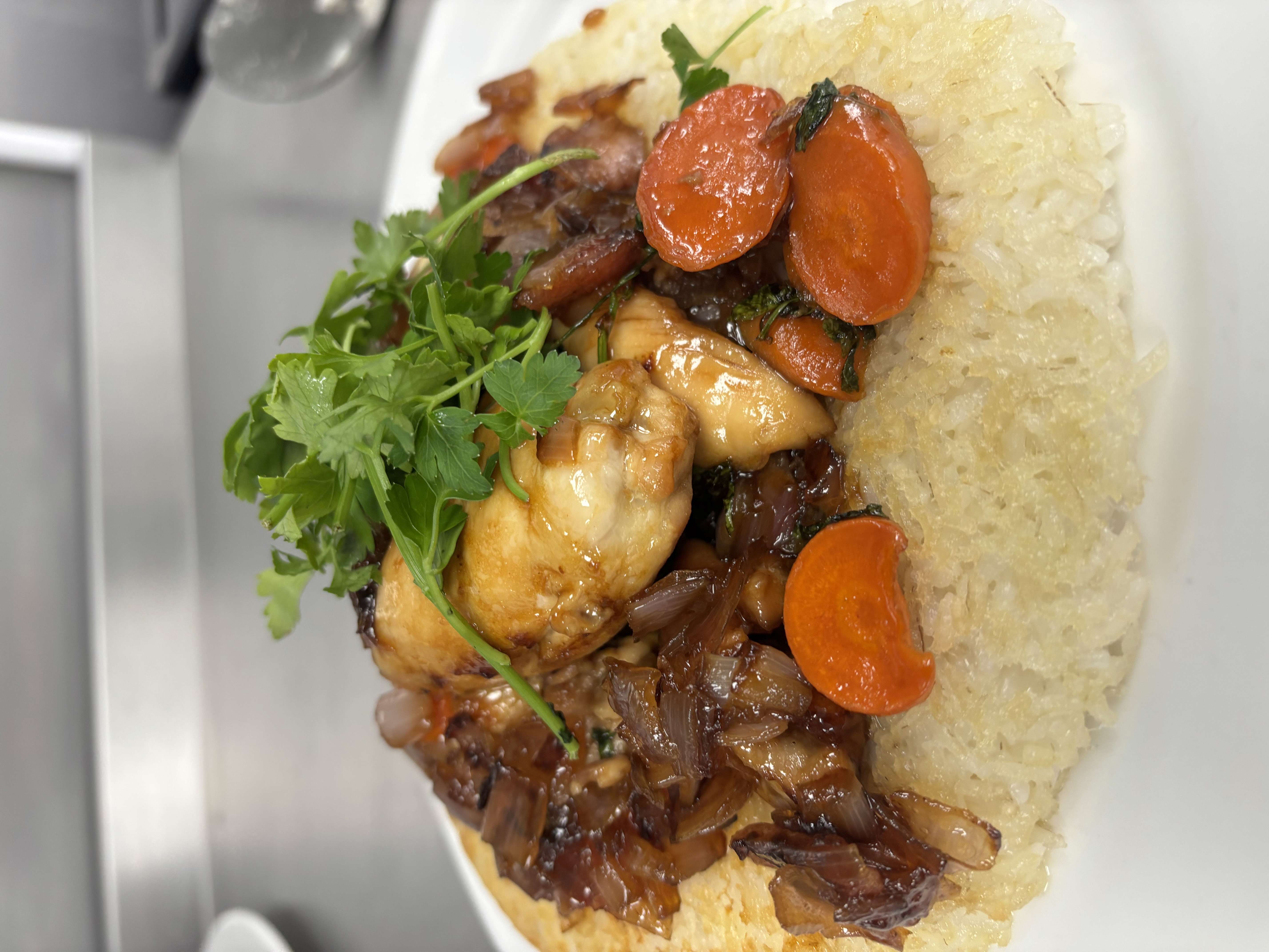 Main image: Sticky Marmalade Chicken on a bed of Crispy Fried Rice and slow cooked onions, with a bunch of parsley on the top.