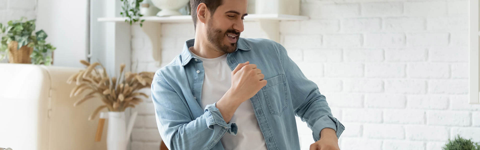 A young man dancing in the kitchen