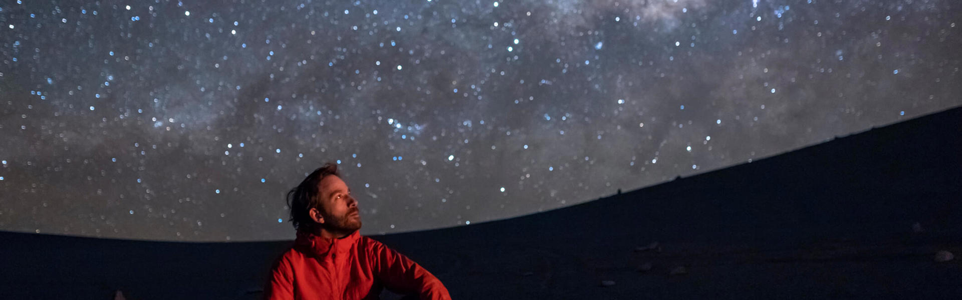 A man looking at the night sky