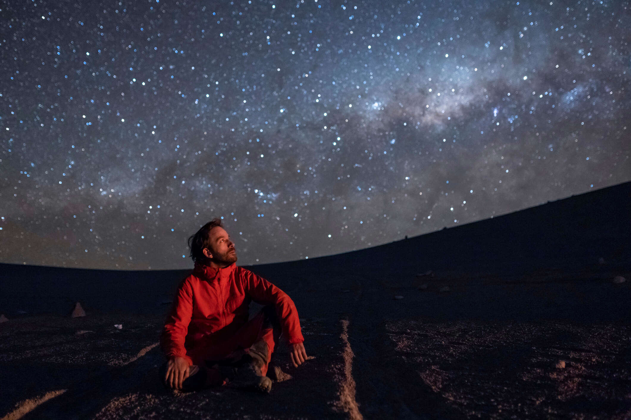 A man looking at the night sky