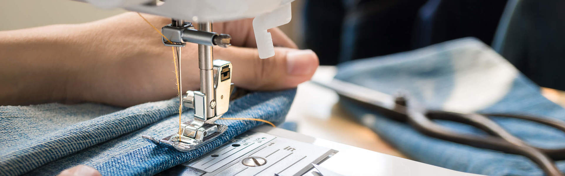 a close up of someone sewing fabric using a sewing machine