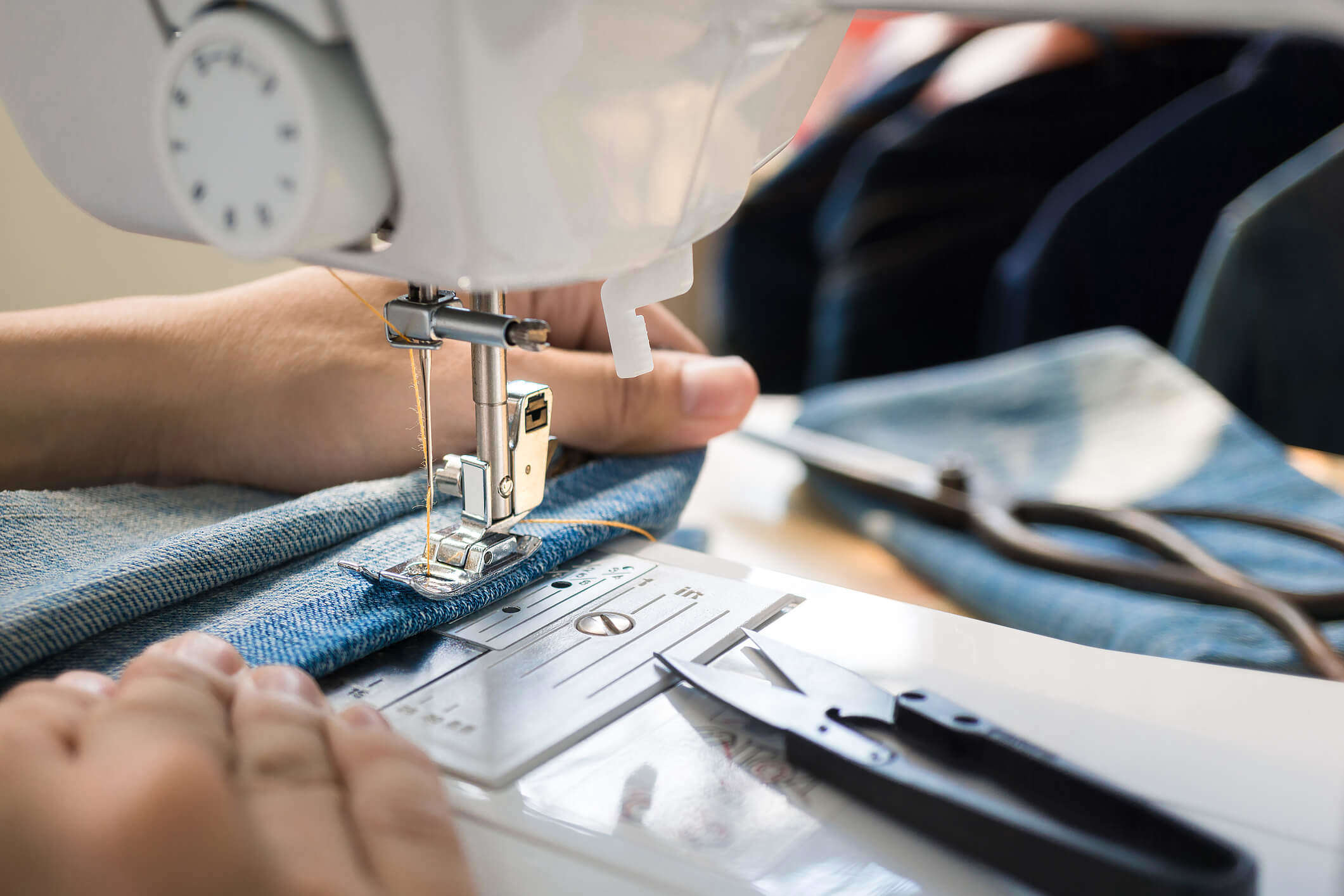 a close up of someone sewing fabric using a sewing machine