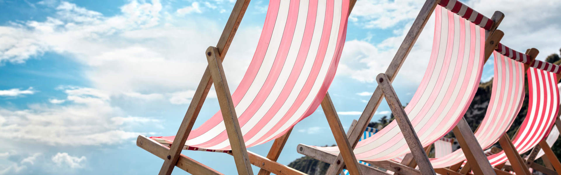 Deck chairs on the beach at the seaside summer vacation