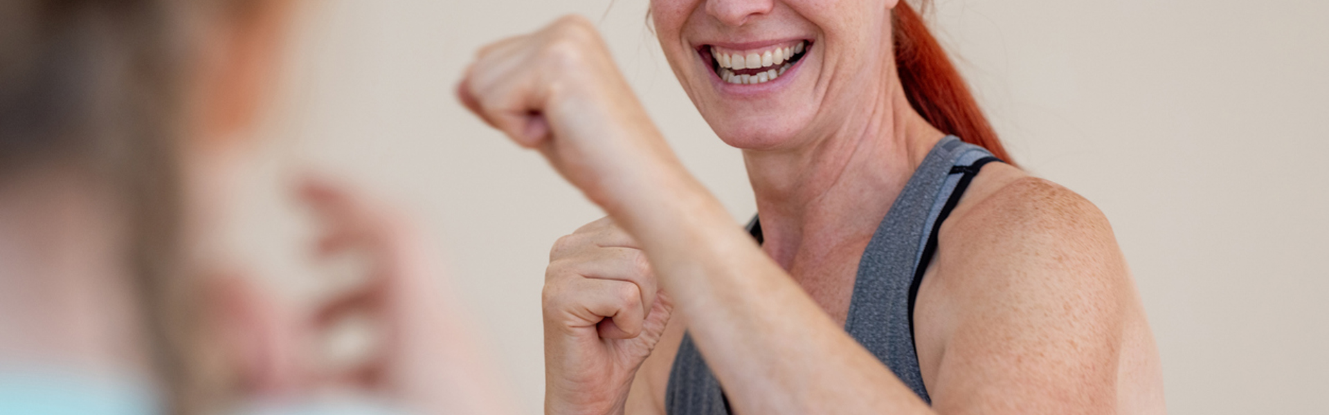 a woman with red hair with her hands up in a boxing position