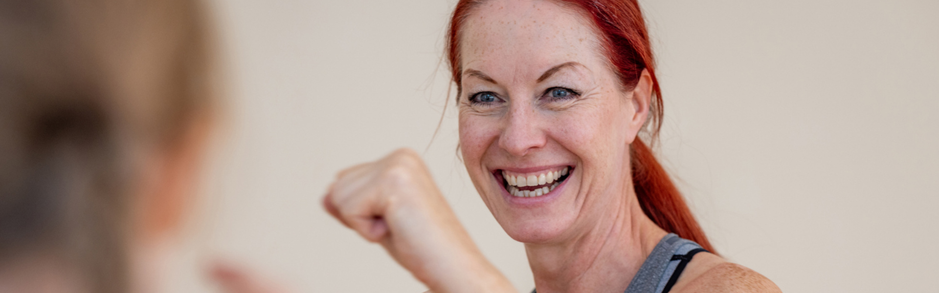 a woman with red hair with her hands up in a boxing position